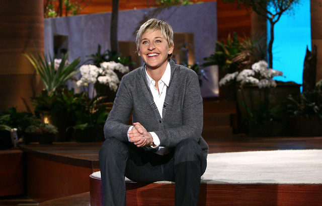Ellen DeGeneres sitting on stage.